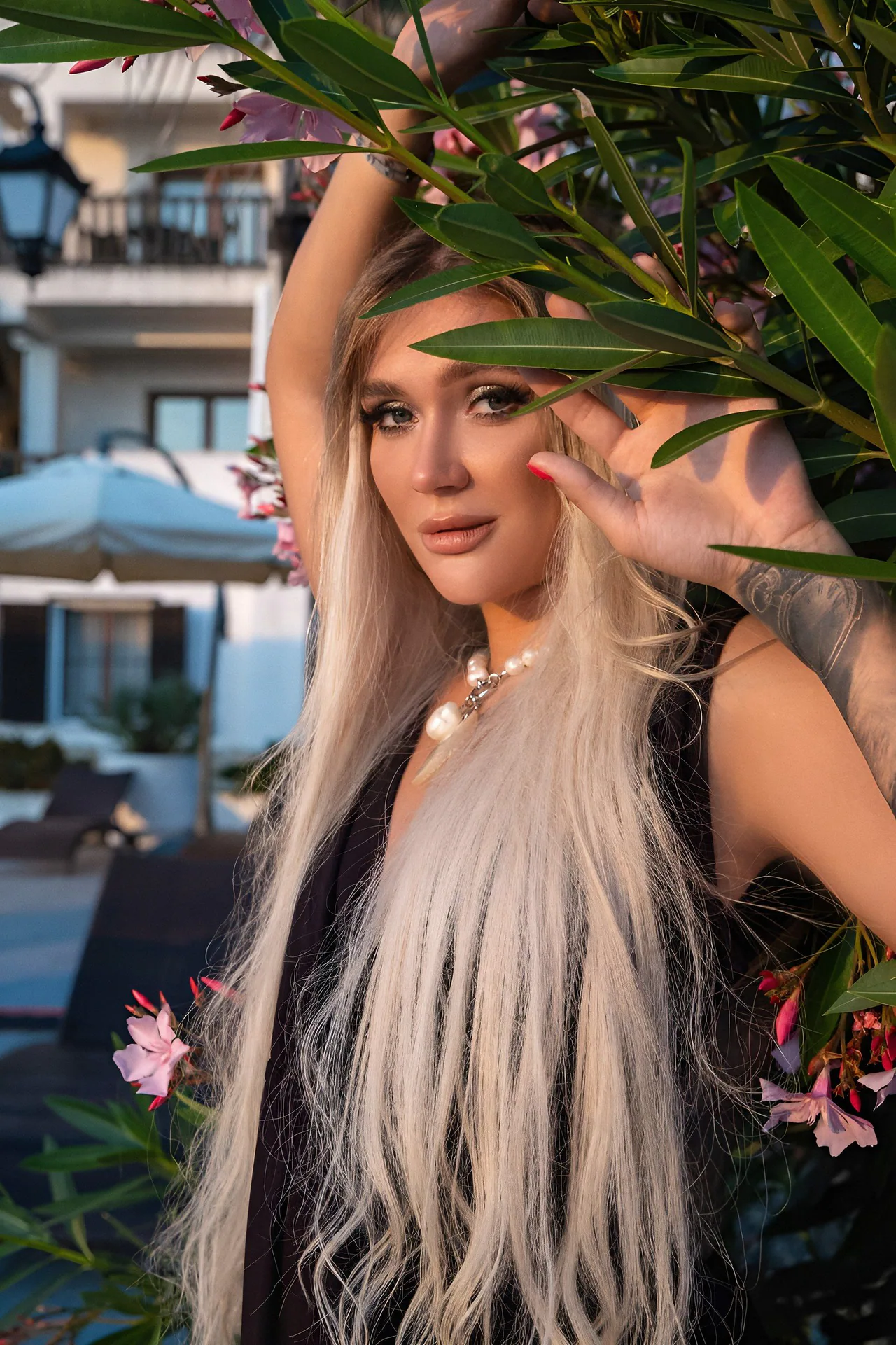 Portrait of Zanna framed by bougainvillea at a Mediterranean resort